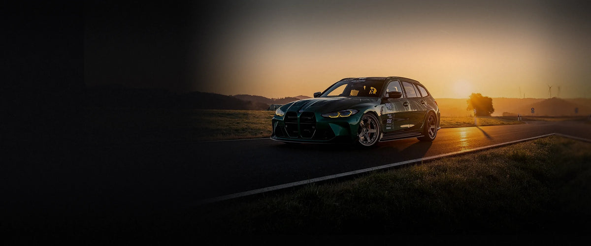 BMW M3 Touring with a Milltek Sport exhaust on a track at sunset